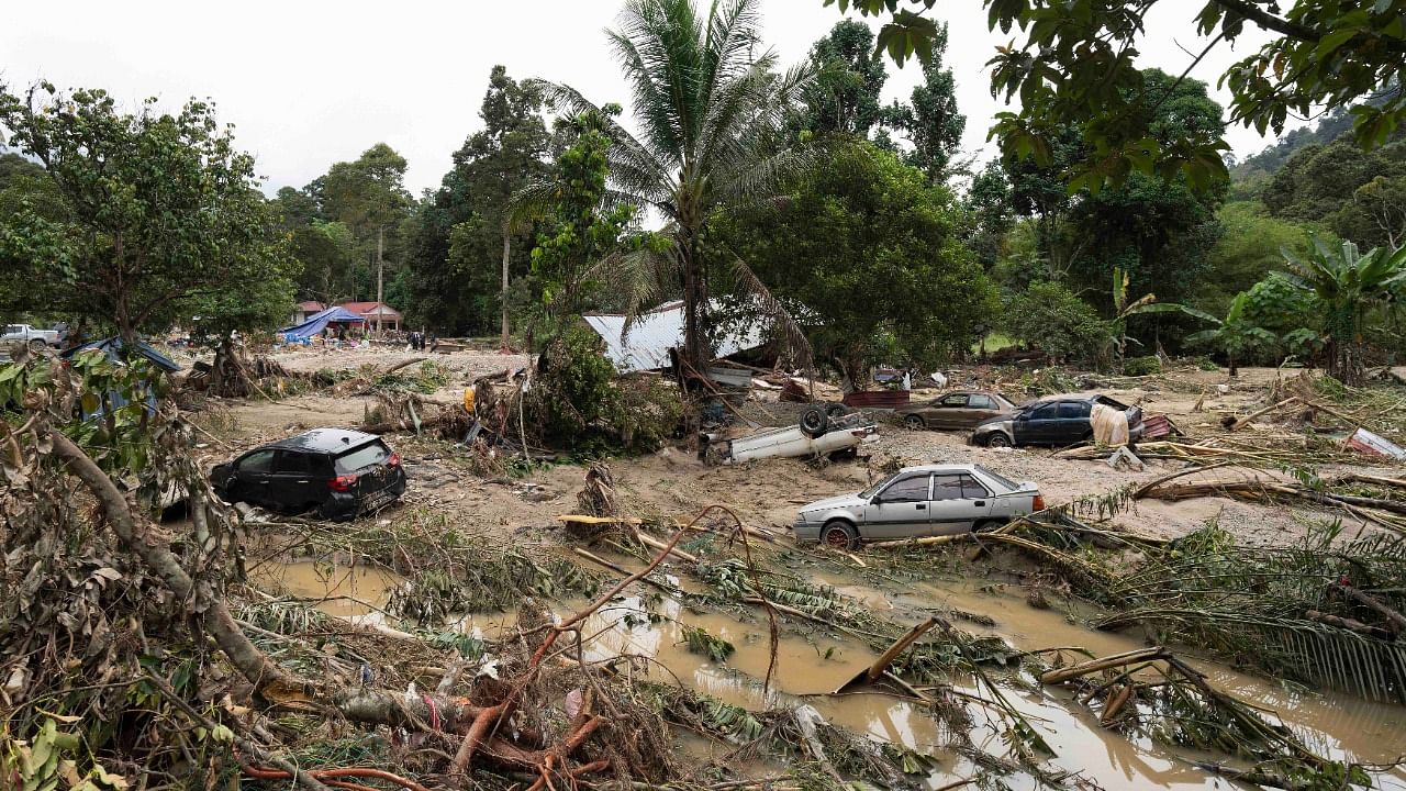 Damaged cars are seen on a riverside after the flooding at Hulu Langat, outskirt of Kuala Lumpur, Malaysia. Credit: AP/PTI File Photo