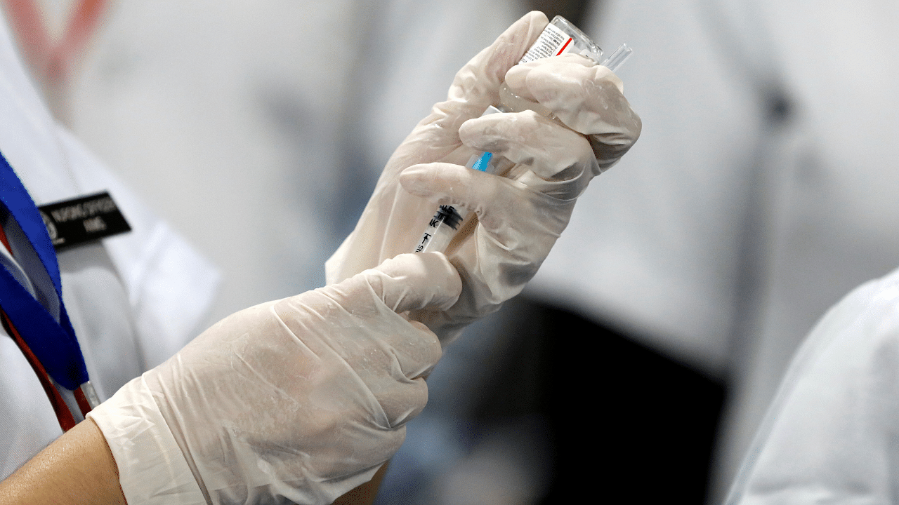 A healthcare worker fills a syringe with a dose of Bharat Biotech's Covid-19 vaccine. Credit: Reuters Photo