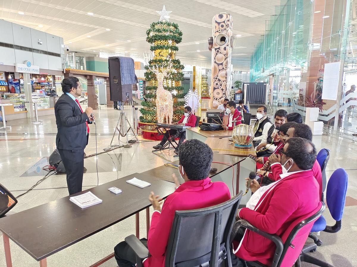 Artistes singing Christmas carols at Mangaluru International Airport.
