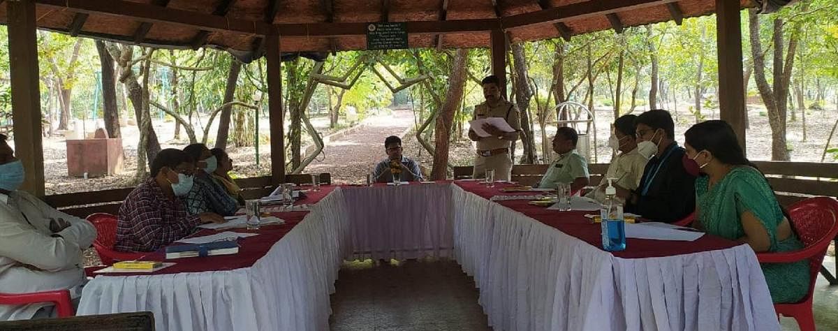 Kundapura DCF Ashish Reddy chairs a meeting at the Saalumarada Thimmakka Tree Park in Manipal.