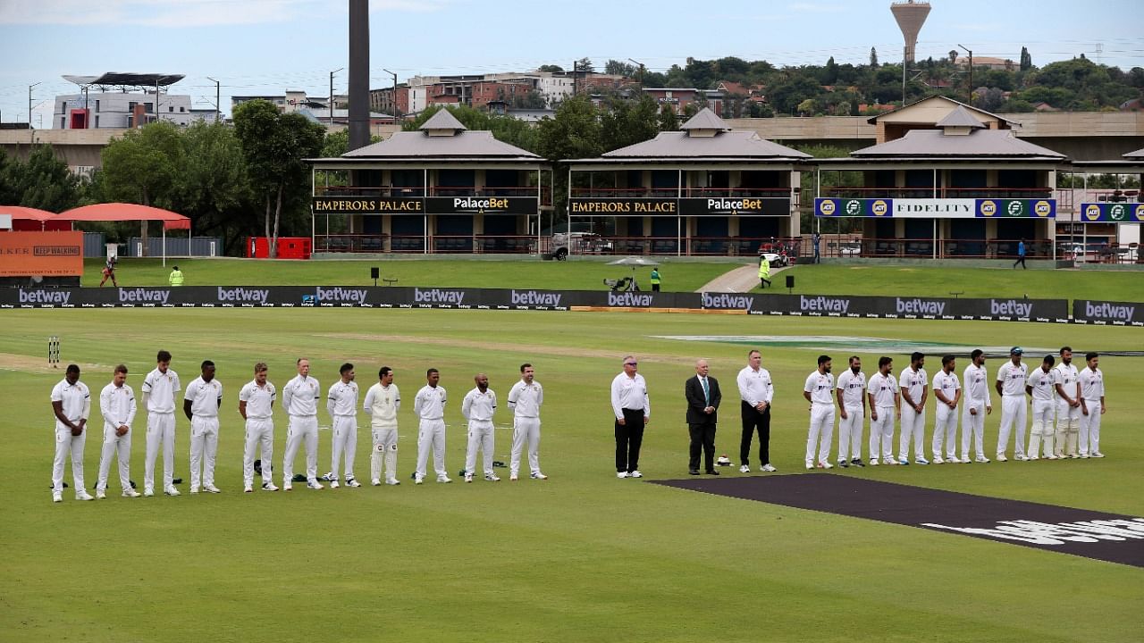 Players and officials during a moment of silence for the passing of Archbishop Desmond Tutu. Credit: PTI Photo