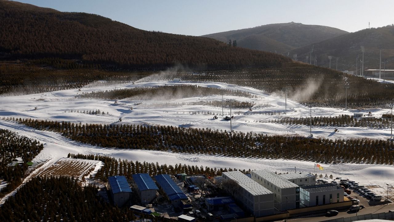 Trees and snow guns operating are seen on slopes near the National Ski Jumping Centre during a government-organised media tour to Beijing 2022 Winter Olympics venues in Zhangjiakou, Hebei province. Credit: Reuters Photo