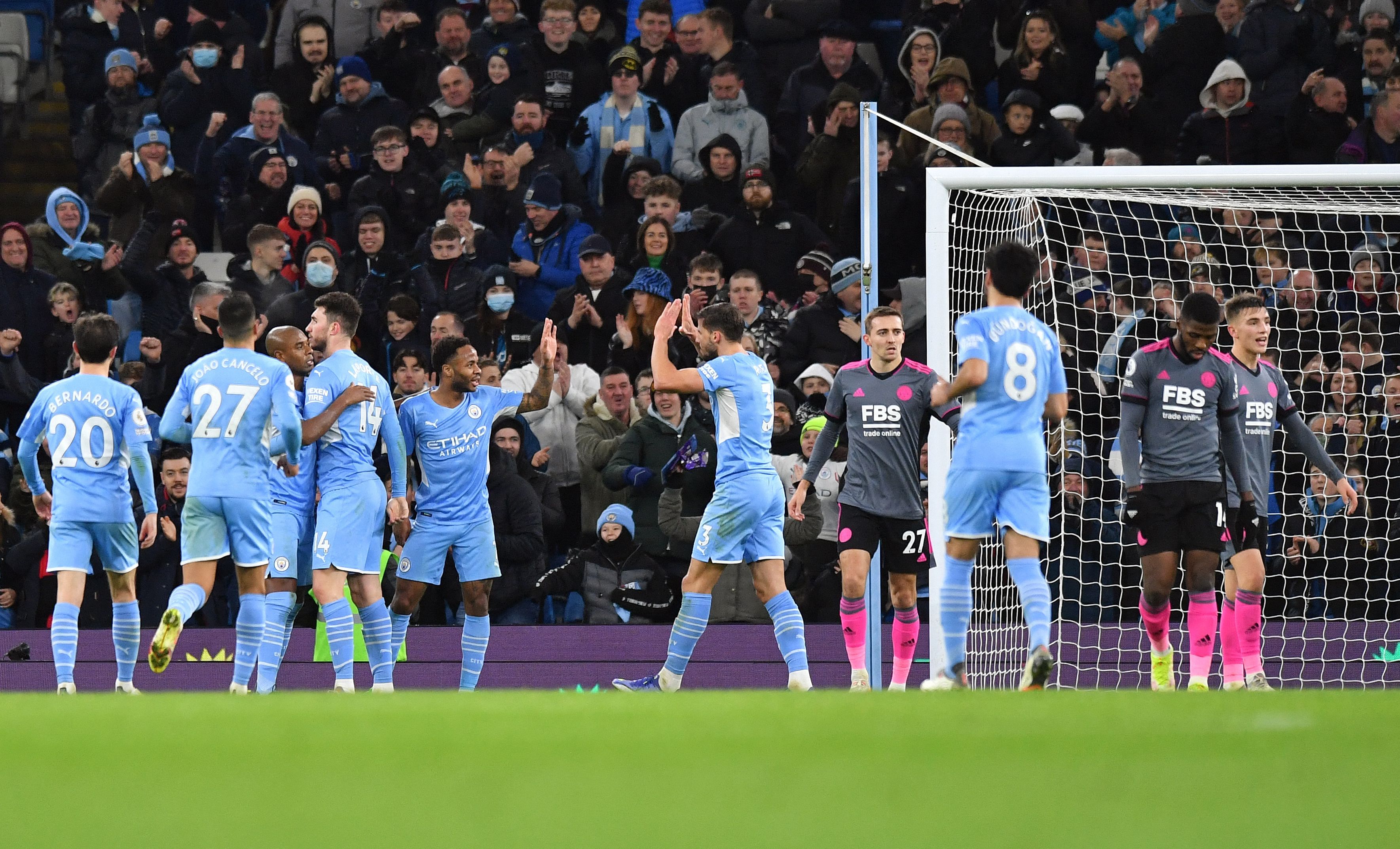 Manchester City players celebrate after scoring a goal against Leicester. Credit: AFP Photo