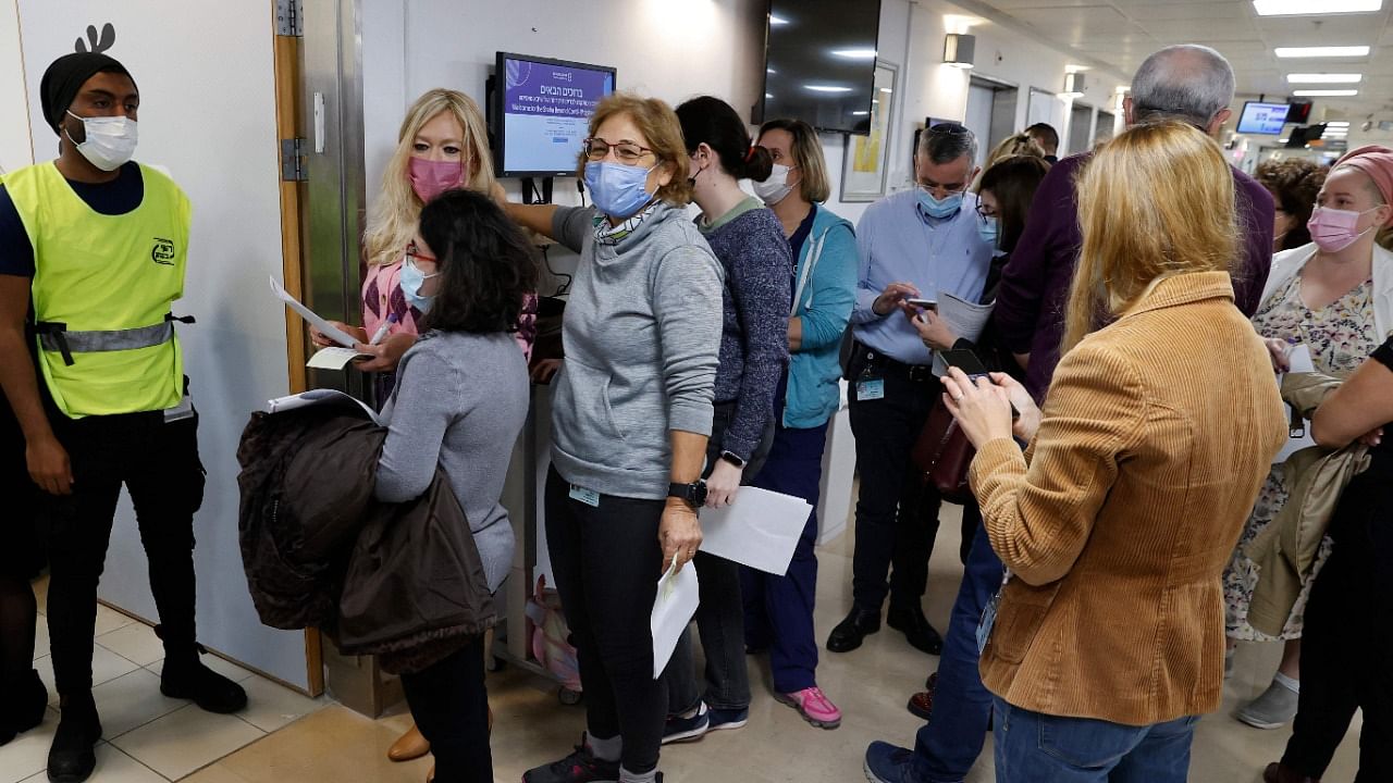 Staff volunteers queue to receive a fourth dose of the Pfizer-BioNTech coronavirus vaccine at the Sheba Medical Center in Ramat Gan. Credit: AFP Photo