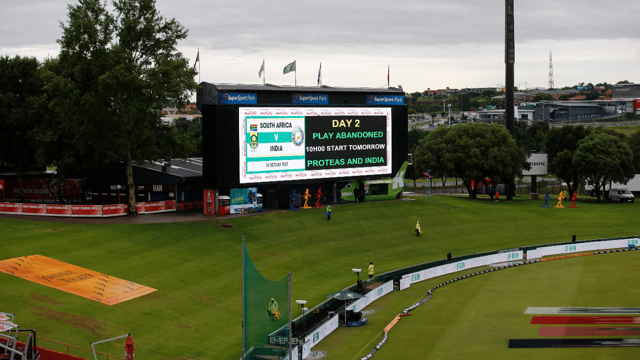 A digital board displays a message that play has been abandoned due to rain during the second day of the first Test cricket match between South Africa and India. Credit: AP Photo
