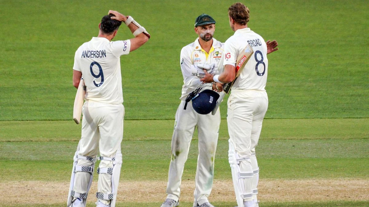 Australia's Nathan Lyon (C) shakes hands with England's last batting pair Jimmy Anderson (L) and Stuart Broad at the end of the second cricket Test match of the Ashes. Credit: AFP Photo