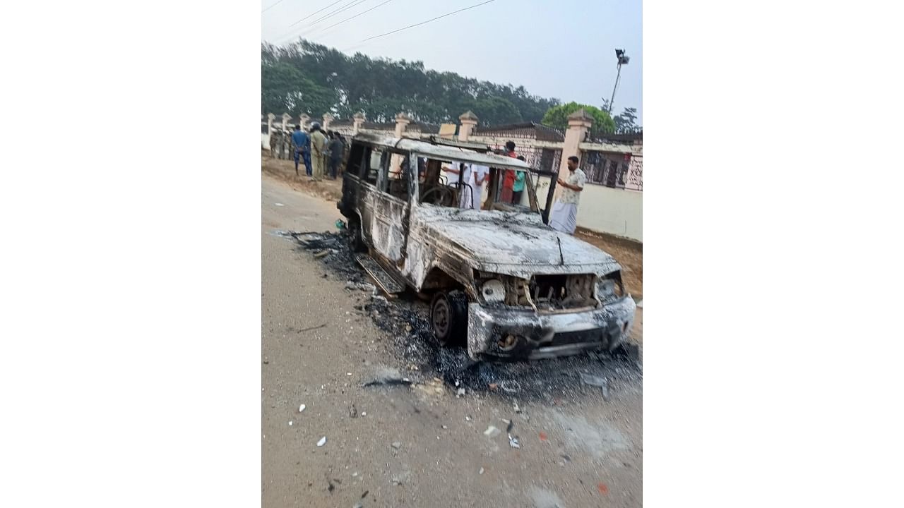 The police jeep that was set ablaze during the violent clash. Credit: DH Photo