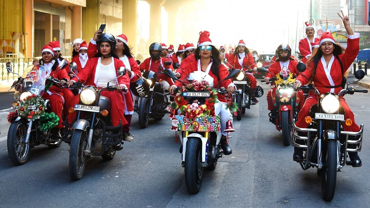 Members of She for Society wearing Santa Claus costumes take part in a bike rally in support of veteran army families on the occasion of the Christmas festival, in Bengaluru on Saturday, December 25, 2021. Credit: IANS File Photo