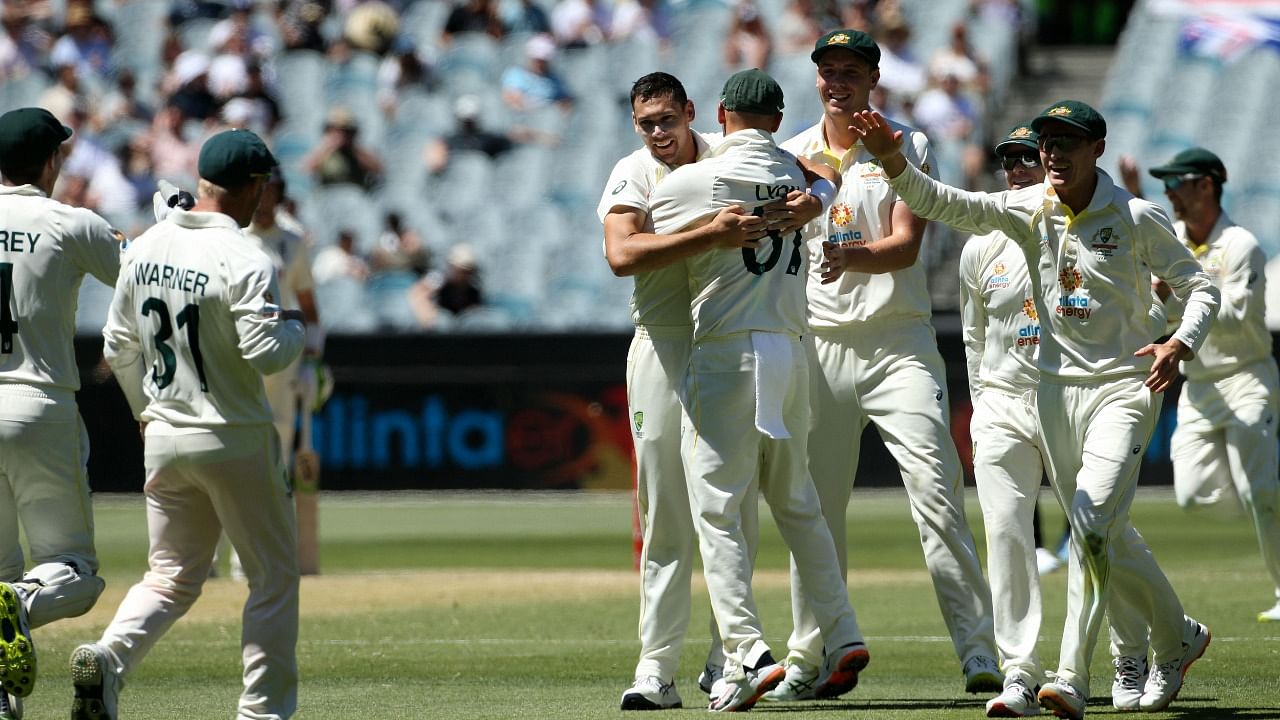 Australia's Scott Boland (C) celebrates the wicket of England's Joe Root (not pictured) with teammates on day three of the third Ashes cricket Test. Credit: AFP Photo