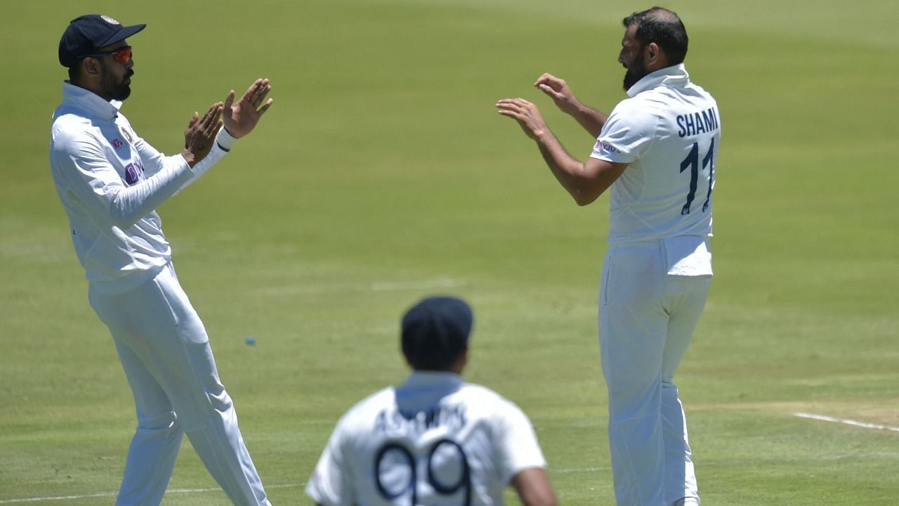 Mohammed Shami (R) celebrates with teammates after the dismissal of South Africa's Keegan Petersen. Credit: AFP Photo
