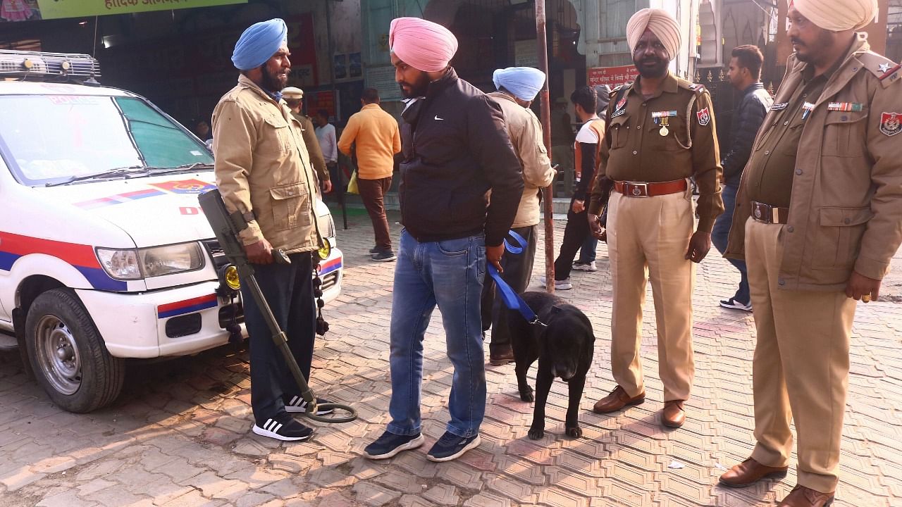Security personnel stand guard outside Mata Kali Temple, a day after a blast in Ludhiana court, in Patiala, Friday, December 24, 2021. Credit: PTI Photo