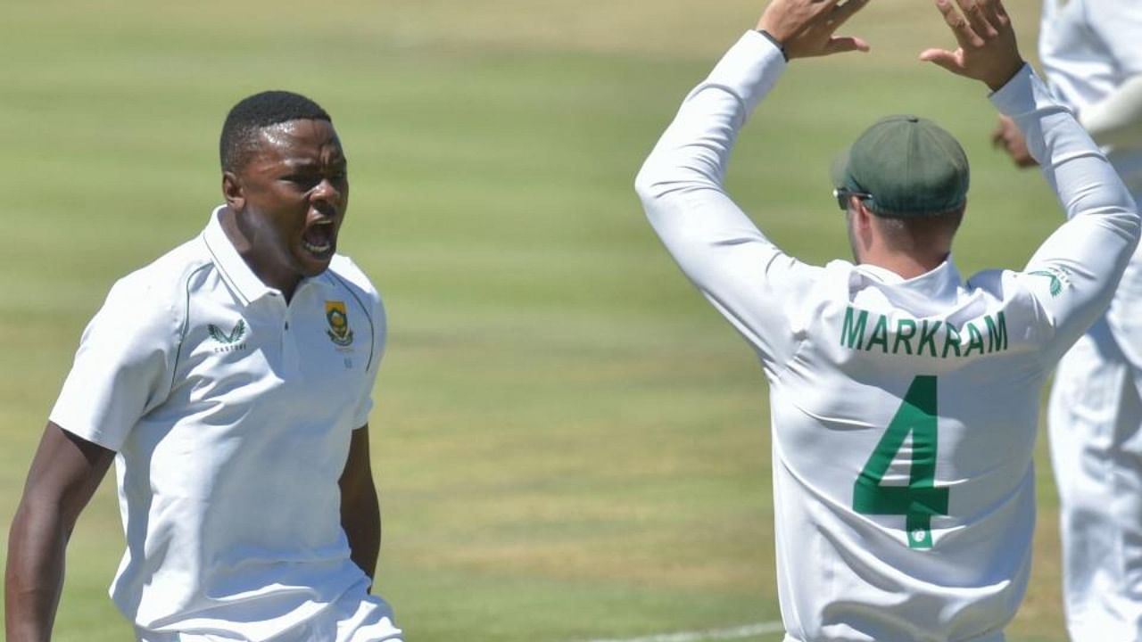 South Africa's Kagiso Rabada (L) celebrates with teaamate South Africa's Aiden Markram (R) after the dismissal of India's KL Rahul (not seen) during the third day of the first Test cricket match between South Africa and India at SuperSport Park in Centurion on December 28, 2021. Credit: AFP Photo