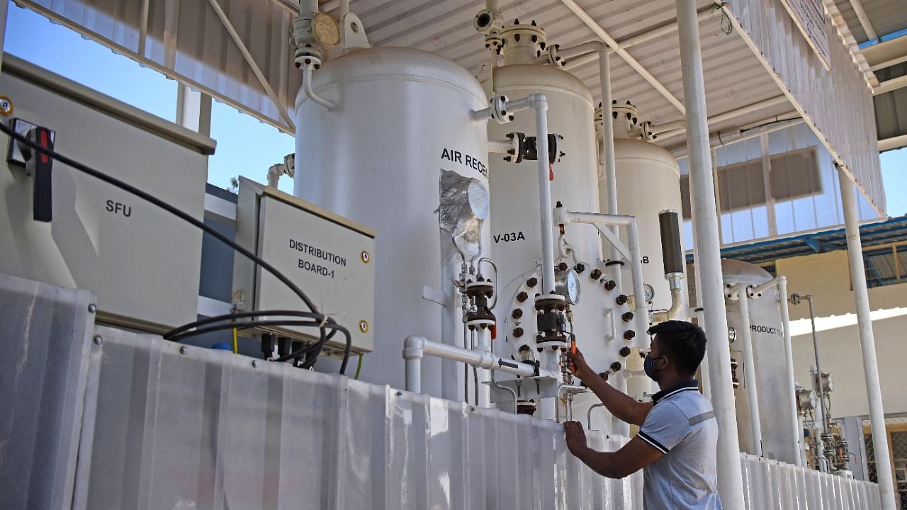 A staffer operates the oxygen plant during mock drill at Sir C V Raman General Hospital in Bengaluru on Tuesday. Credit: DH Photo/Pushkar V
