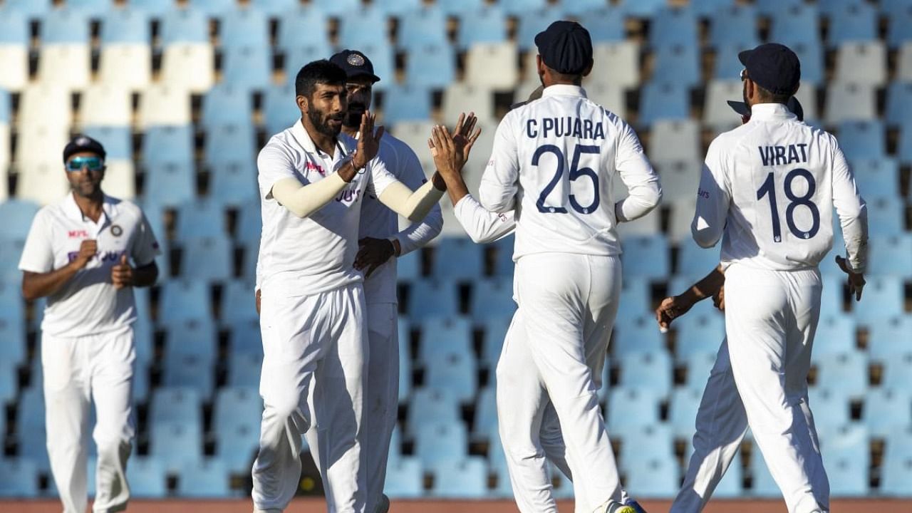 India's bowler Jasprit Bumrah celebrates with teammates after bowling South Africa's batsman Rassie van der Dussen, during the fourth day of the Test Cricket match between South Africa and India at Centurion Park in Pretoria, South Africa. Credit: AFP Photo