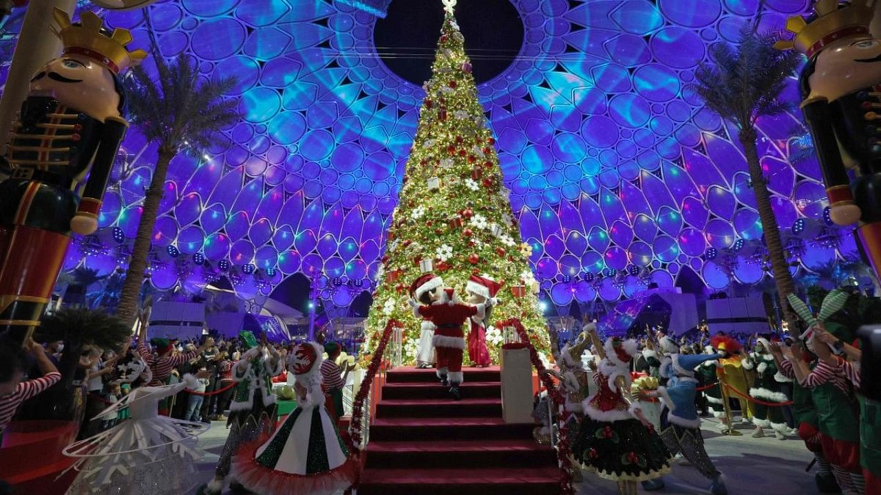A picture taken on December 18, 2021 shows the lighting the Christmas tree at the al-Wasl Dome at Expo 2020 in the gulf emirate of Dubai. Credit: AFP Photo