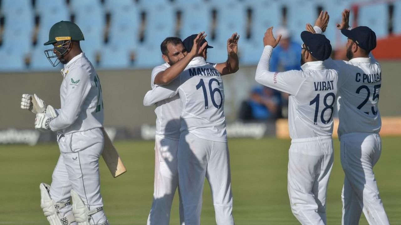 South Africa's Kagiso Rabada (L) walks back to the pavilion after his dismissal by India's Mohammed Shami (2nd L) during the third day of the first Test cricket match between South Africa and India at SuperSport Park in Centurion on December 28, 2021. Credit: AFP Photo