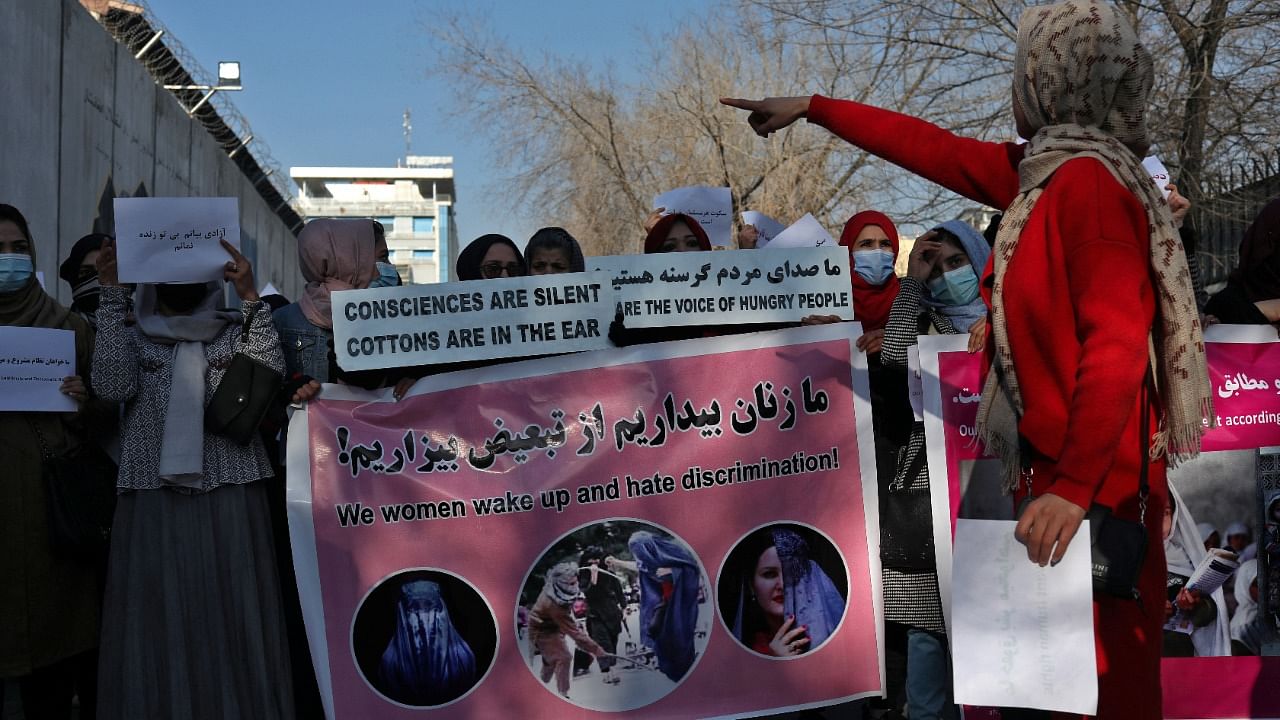 Afghan women hold banners and placards during a rally. Credit: Reuters Photo