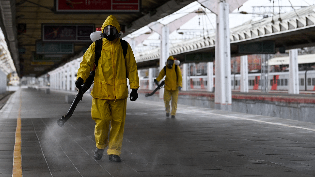 Servicemen of Russia's Emergencies Ministry wearing protective gear disinfect Moscow's Leningradsky railway station. Credit: AFP Photo