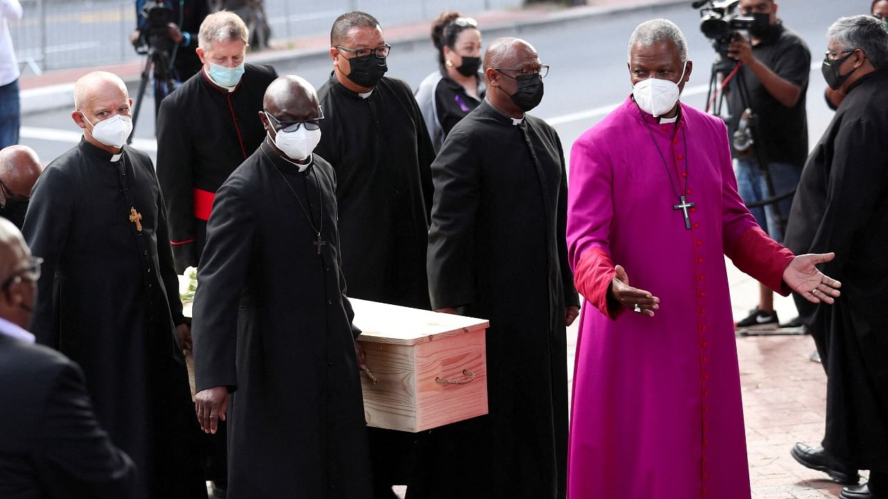 Archbishop Thabo Makgoba gestures as Archbishop Desmond Tutu's coffin arrives at St. Georges Cathedral for his lying in state. Credit: Reuters Photo