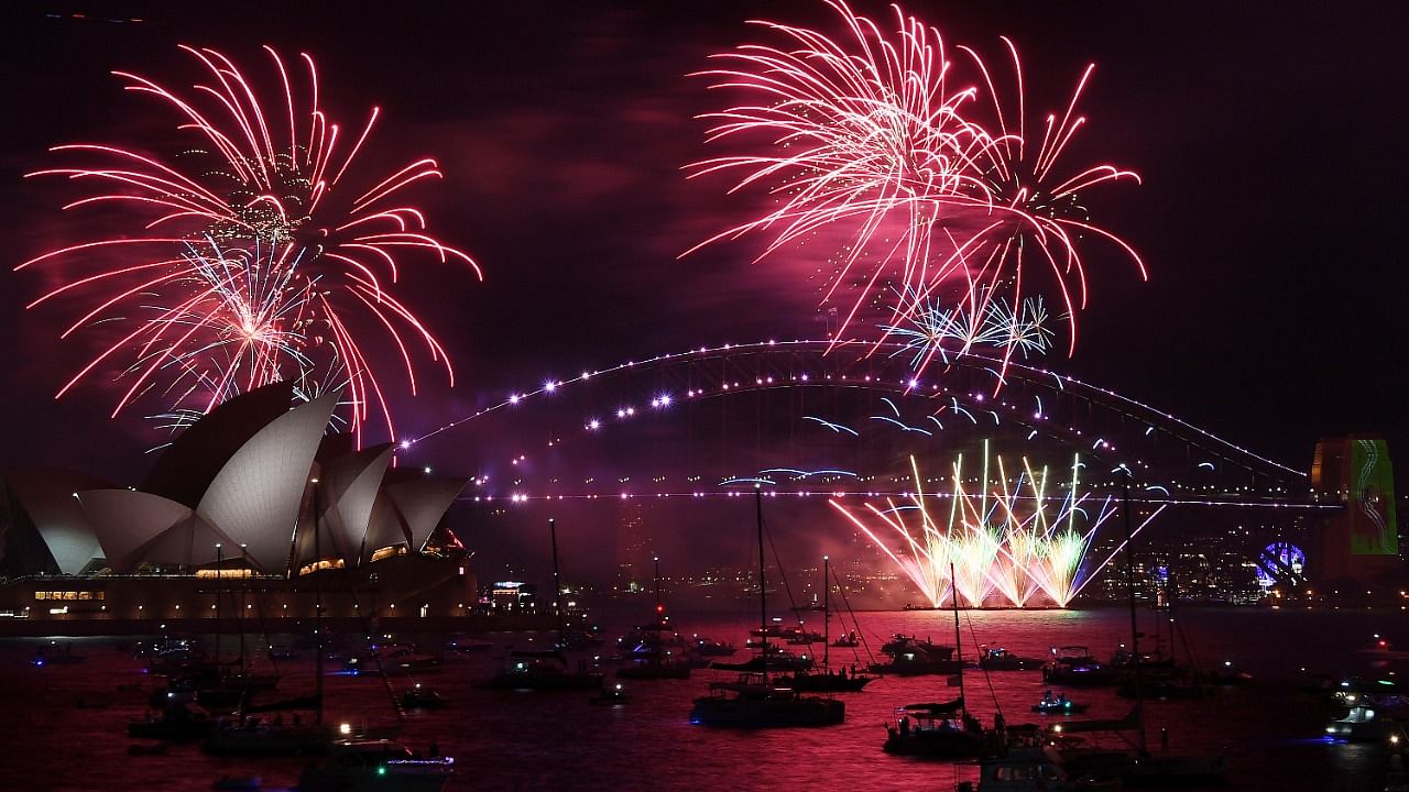 Fireworks explode over the Sydney Opera House and Harbour Bridge as New Year's Eve celebrations begin in Sydney, Friday, December 31, 2021. Credit: AP/PTI Photo