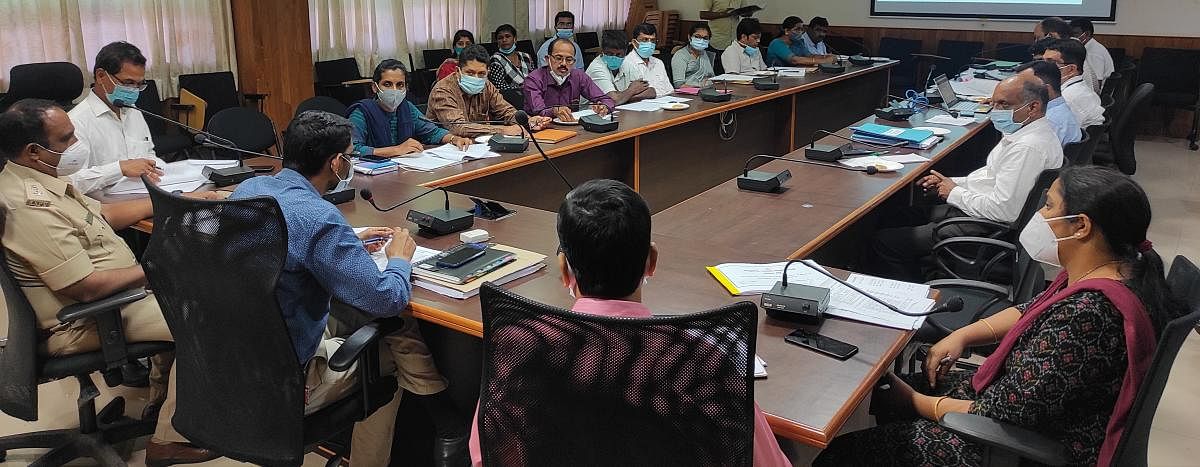 Deputy Commissioner M Kurma Rao chairs a meeting at his office in Manipal.