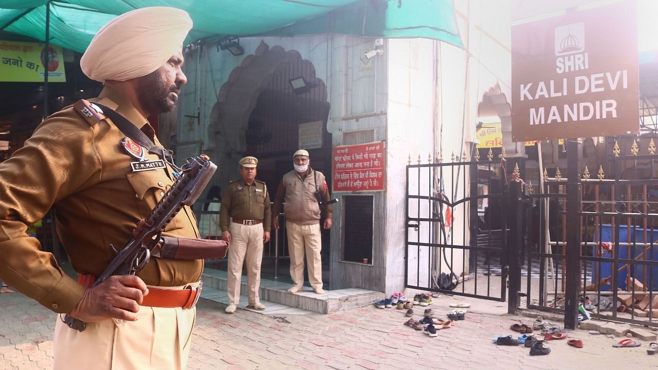 Security personnel stand guard outside Mata Kali Temple, a day after a blast in Ludhiana court, in Patiala. Credit: PTI Photo