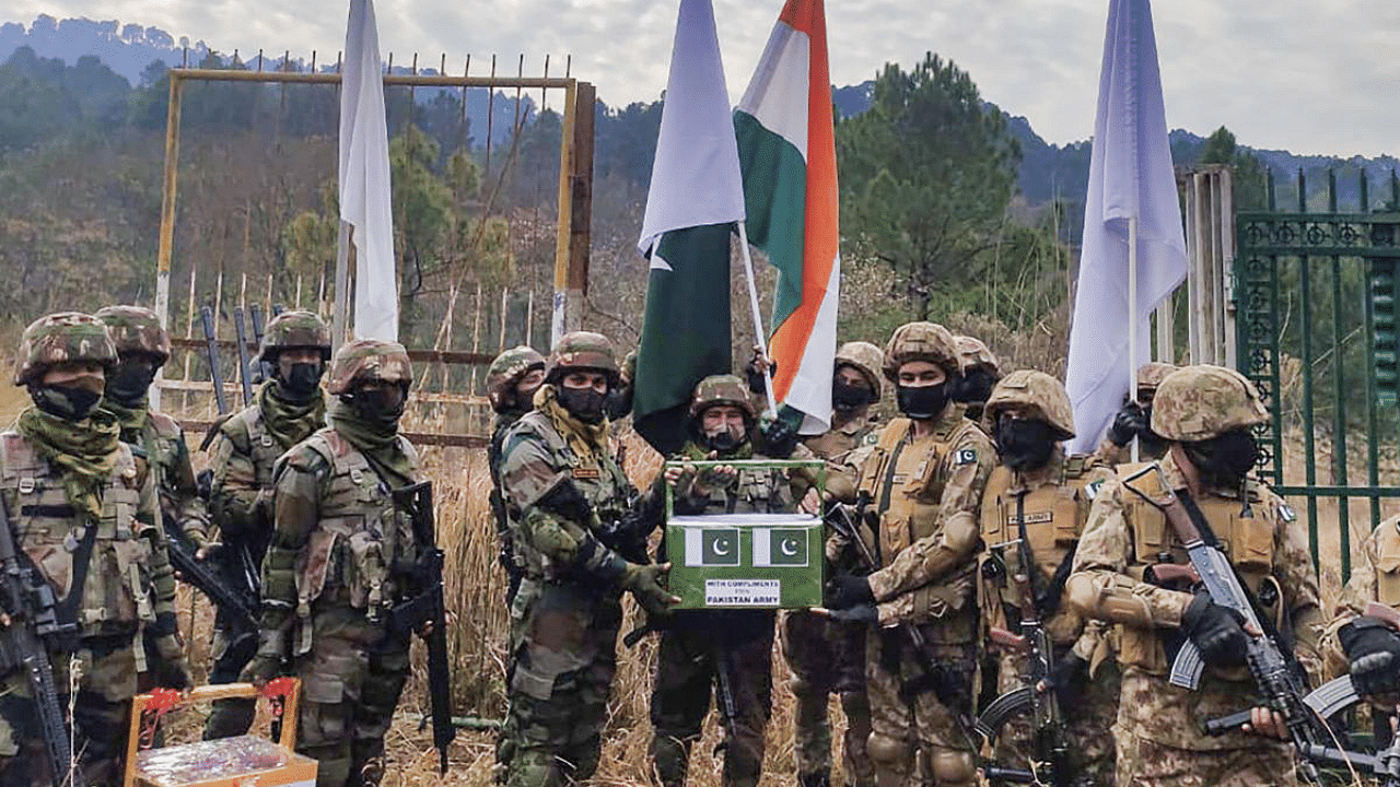 Indian Army soldiers exchange sweets with Pakistan soldiers on New Year day to promote peace, at a Crossing Point in Poonch. Credit: PTI Photo