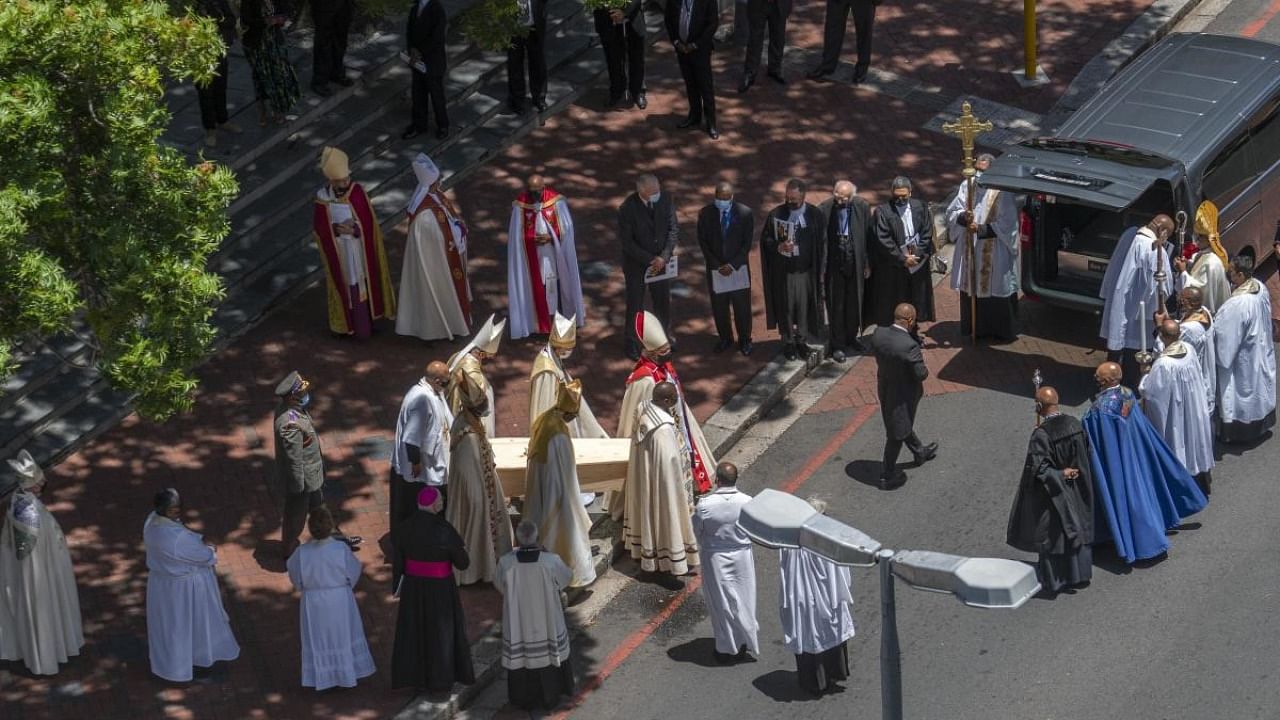 The casket carrying the remains of Anglican Archbishop Emeritus Desmond Tutu is carried out to a hearse following his funeral service at the St. George's Cathedral in Cape Town, South Africa. Credit: AFP Photo