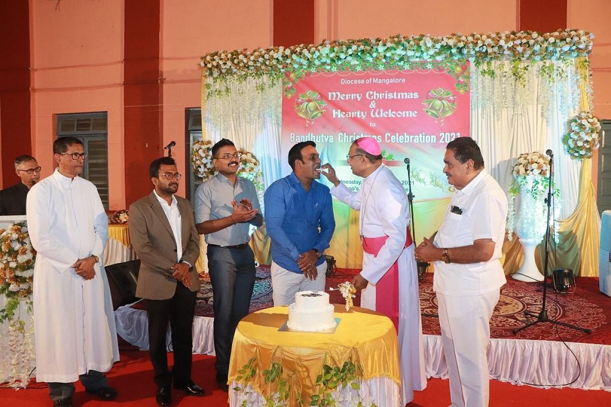 Mangalore Diocese Bishop Rev Dr Peter Paul Saldanha feeds a piece of cake to City Police Commissioner N Shashi Kumar during Bandhutva Christmas Celebration at Bishop’s house in Mangaluru.