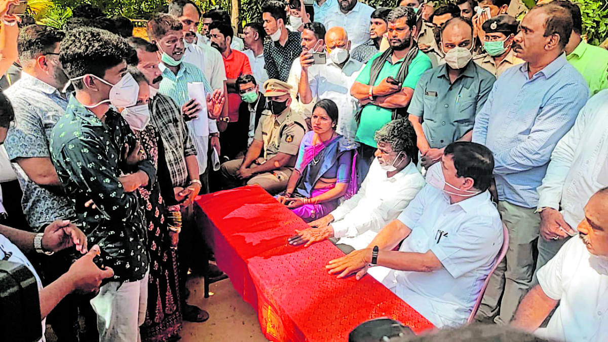 Home Minister Araga Jnanendra interacts with the victims of alleged police atrocities at Kota Thattu village in Udupi district on Saturday.