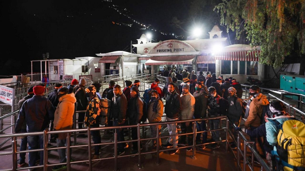 Devotees stand in queue outside Darshani deodi while on their way to Mata Vaishno Devi shrine, in Reasi district. Credit: PTI photo