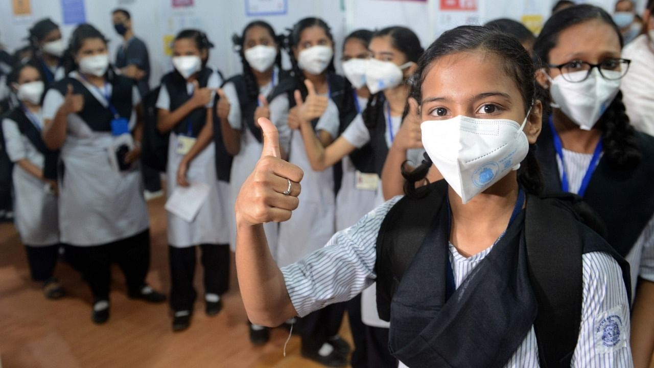School students wait to receive a dose of Covid-19 vaccine to a beneficiary during a vaccination drive for the age group of 15-18 years, at a jumbo Covid-19 centre in the Bandra-Kurla Complex (BKC) in Mumbai on Monday, January 3, 2022. Credit: IANS Photo