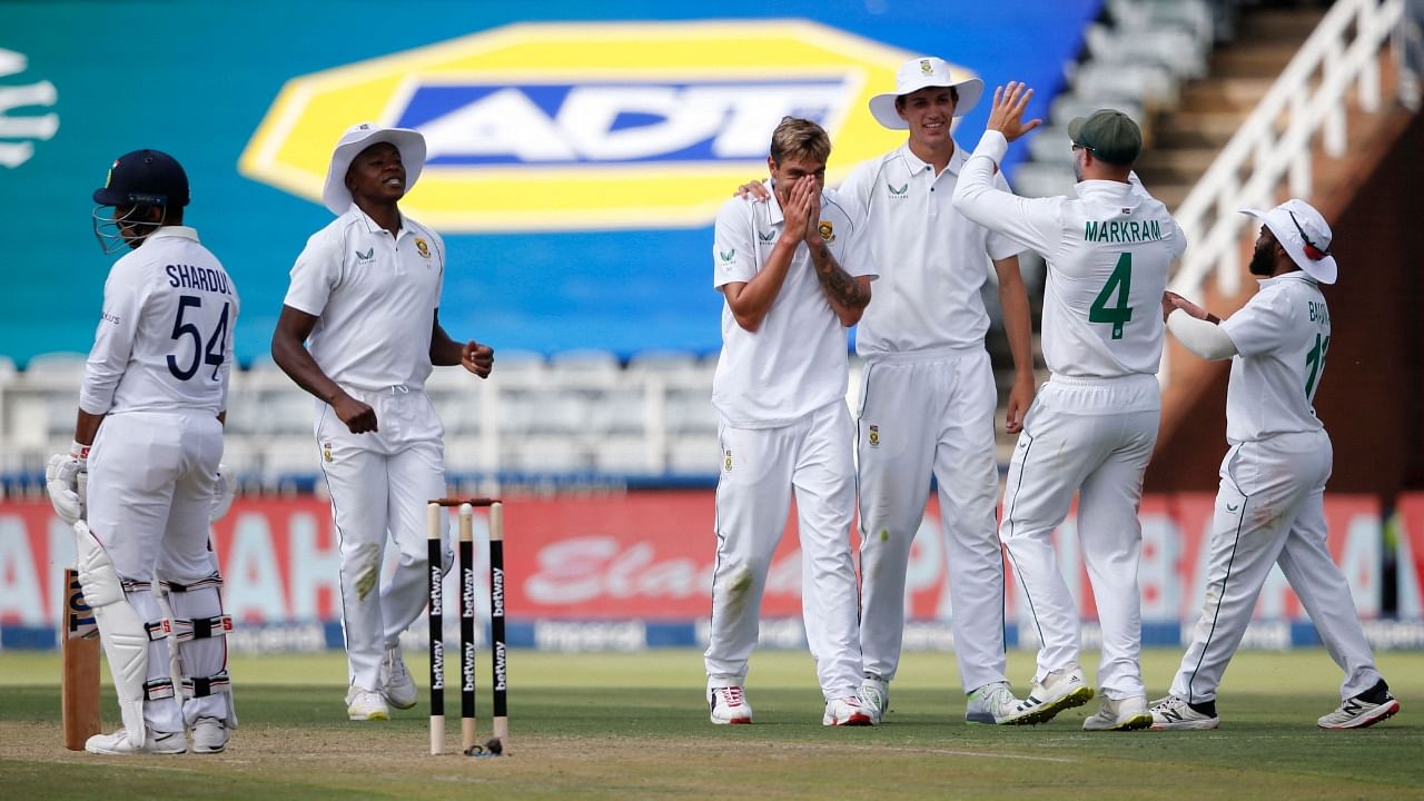 South Africa's Duanne Olivier (C) celebrates with teammates after the dismissal of India's Shardul Thakur (R) during the first day of the second Test against India at The Wanderers Stadium in Johannesburg. Credit: AFP Photo