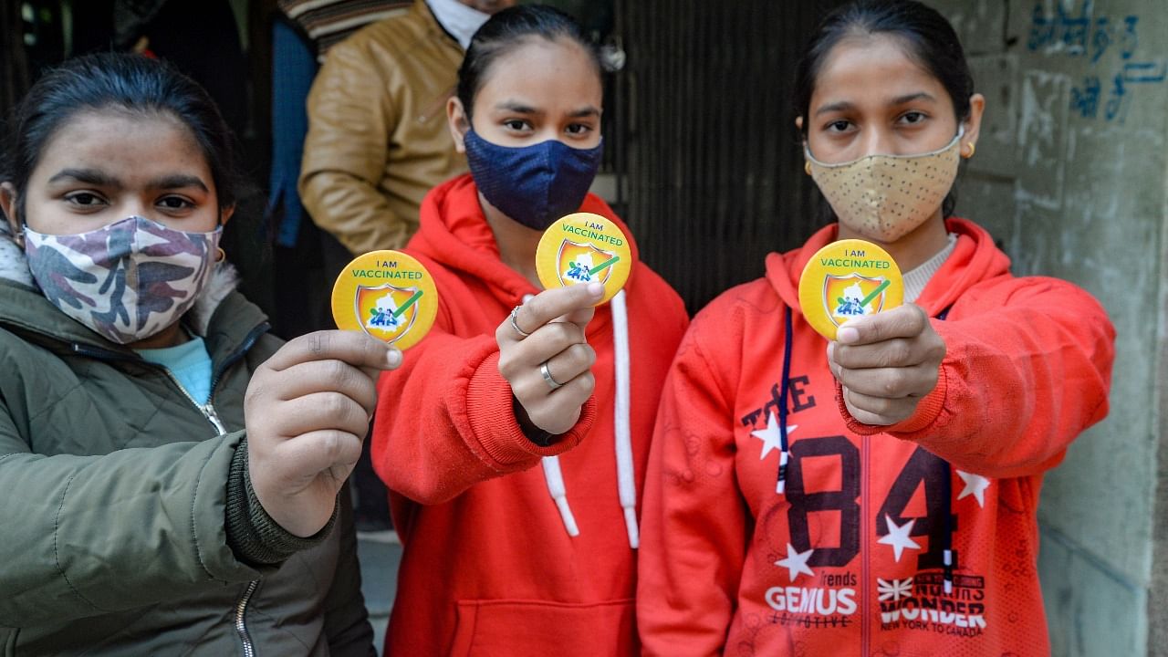 Students pose for photographs after being administered with a Covid-19 vaccine in Jalandhar. Credit: PTI Photo