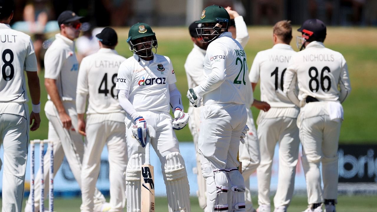 Bangladesh's Mehidy Hasan Miraz (centre left), with team mate Yasir Ali, review an LBW call during play on Day 4. Credit: AP/PTI Photo