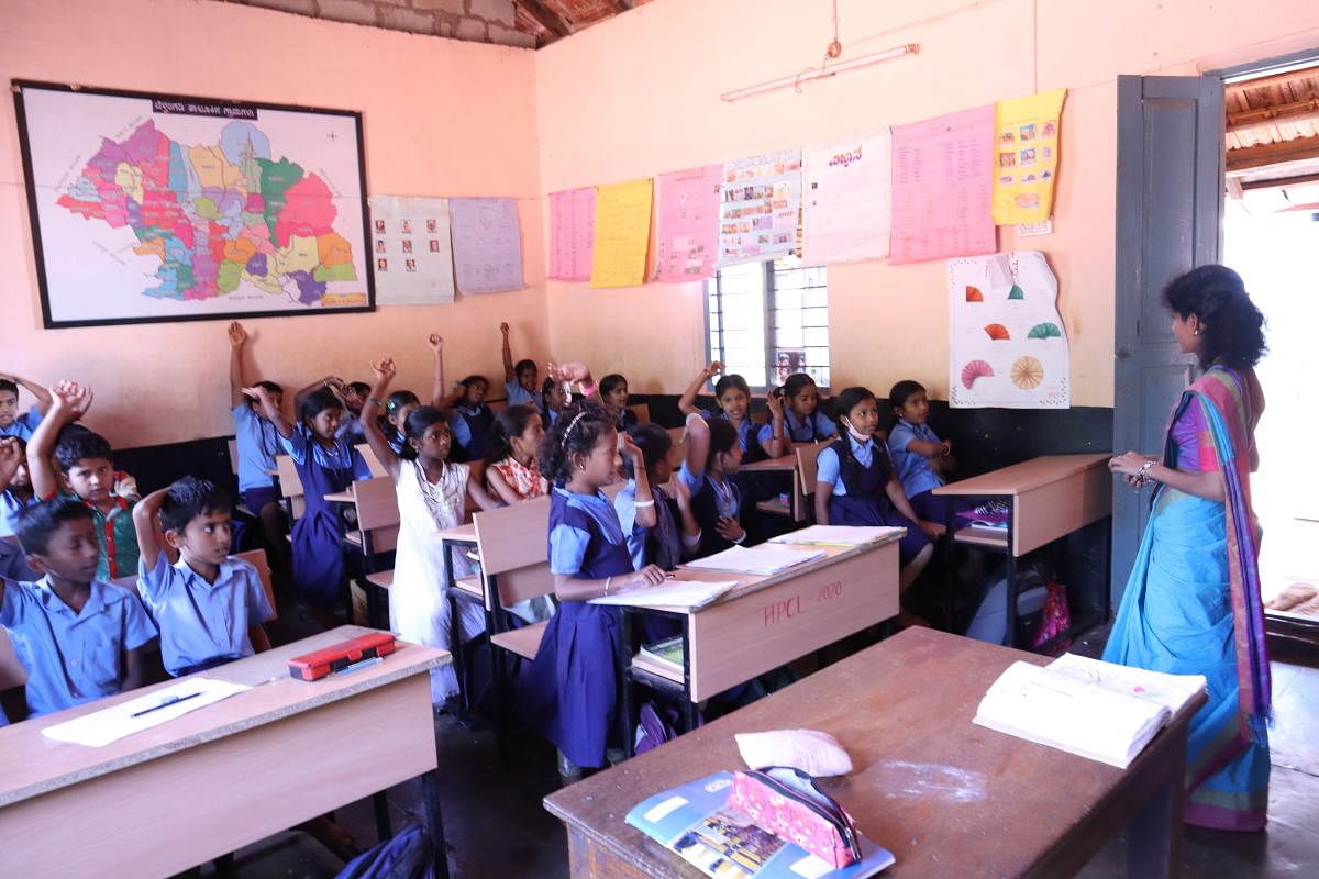 An honorary teacher in a classroom at a school in Kanyadi.