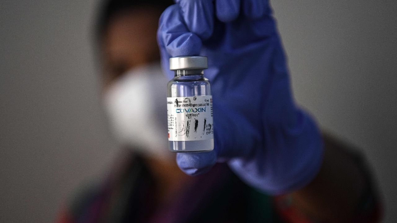 A health worker shows a vial containing the Covaxin vaccine against Covid-19. Credit: AFP Photo