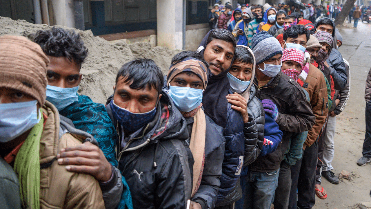 People wait in a long queue to receive Covid-19 vaccine dose at the Civil Hospital. Credit: PTI Photo