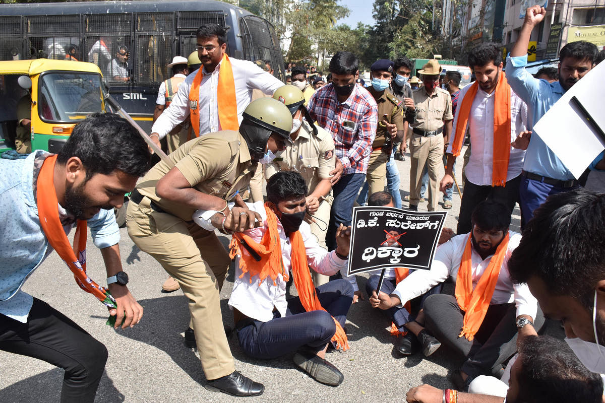 Police evict BJP Yuva Morcha members, who were staging prorest against KPCC president D K Shivakumar and Lok Sabha member D K Suresh, in Bengaluru. Credit: DH Photo