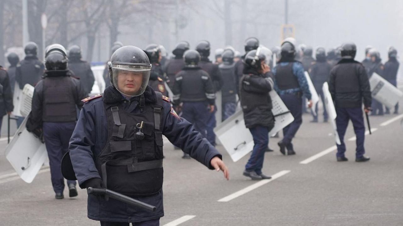 Riot police officers patrol in a street as unprecedented protests over a hike in energy prices spun out of control in Almaty. Credit: AFP Photo