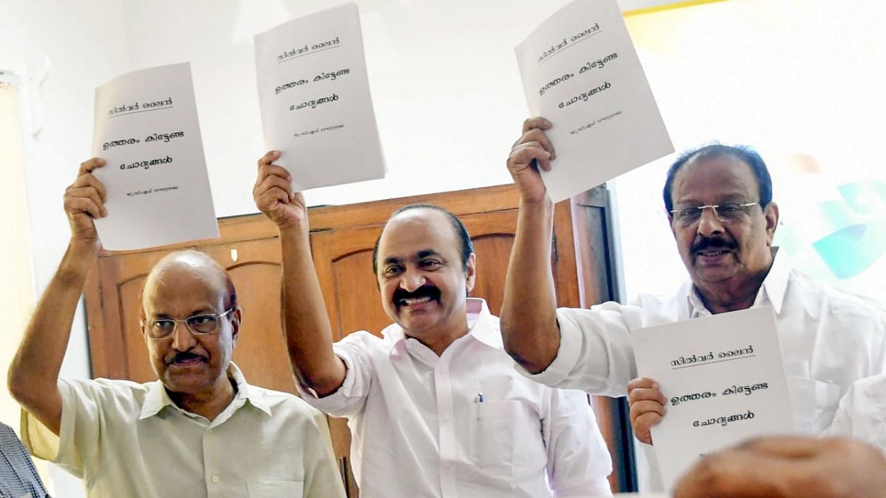 KPCC President K. Sudhakaran (R), Leader of the Opposition in Kerala Assembly V.D. Satheesan (C) and Indian Union Muslim League leader P.K. Kunhalikutty, release a pamphlet of 'unanswered questions' on the state government's K-Rail (SilverLine) project, during a meeting of United Democratic Front, in Thiruvananthapuram. Credit: PTI photo