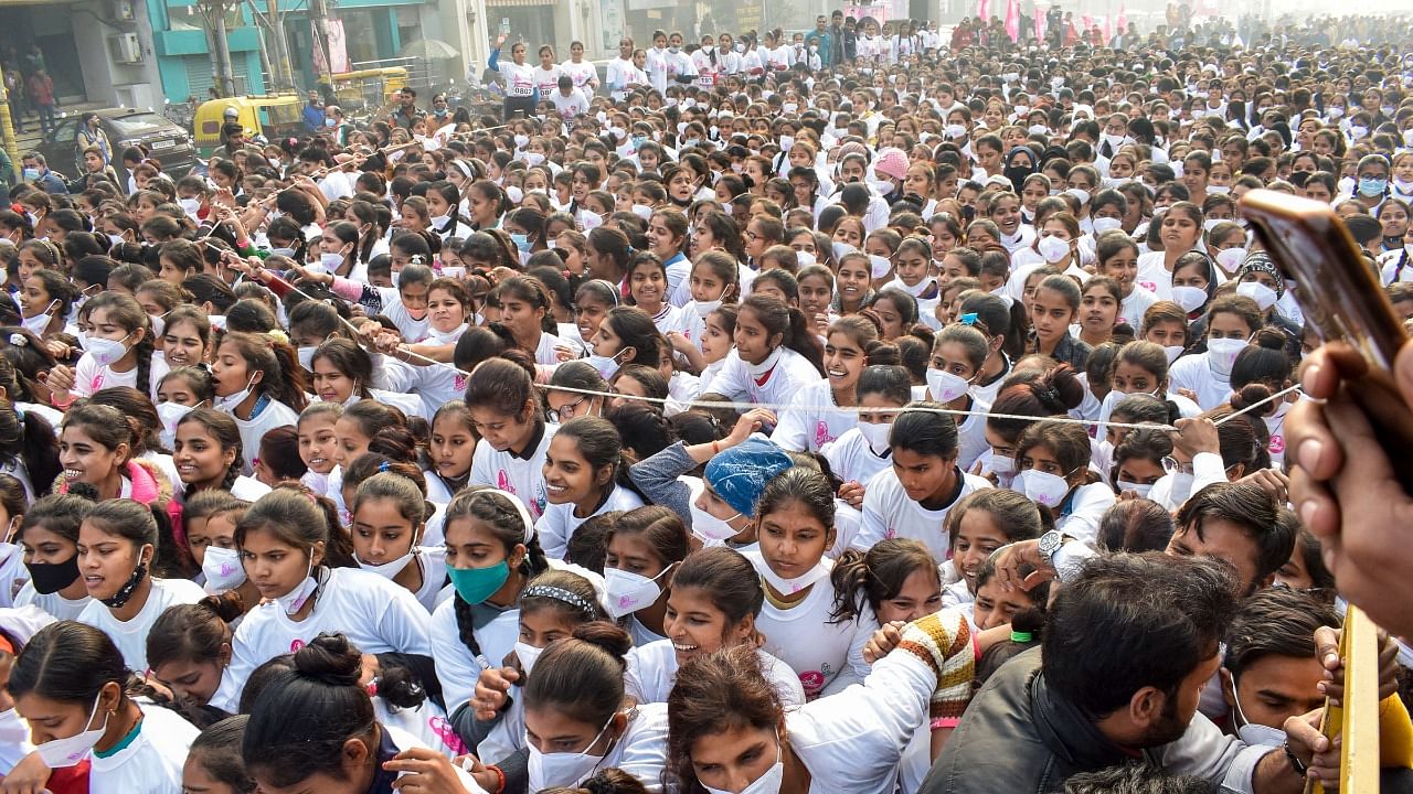 Girls participate in Congress's 'Ladki Hoon Lad Sakti Hoon' marathon in Bareilly, Tuesday, Jan. 4, 2022. A stampede-like situation occured in the marathon. Credit: PTI Photo