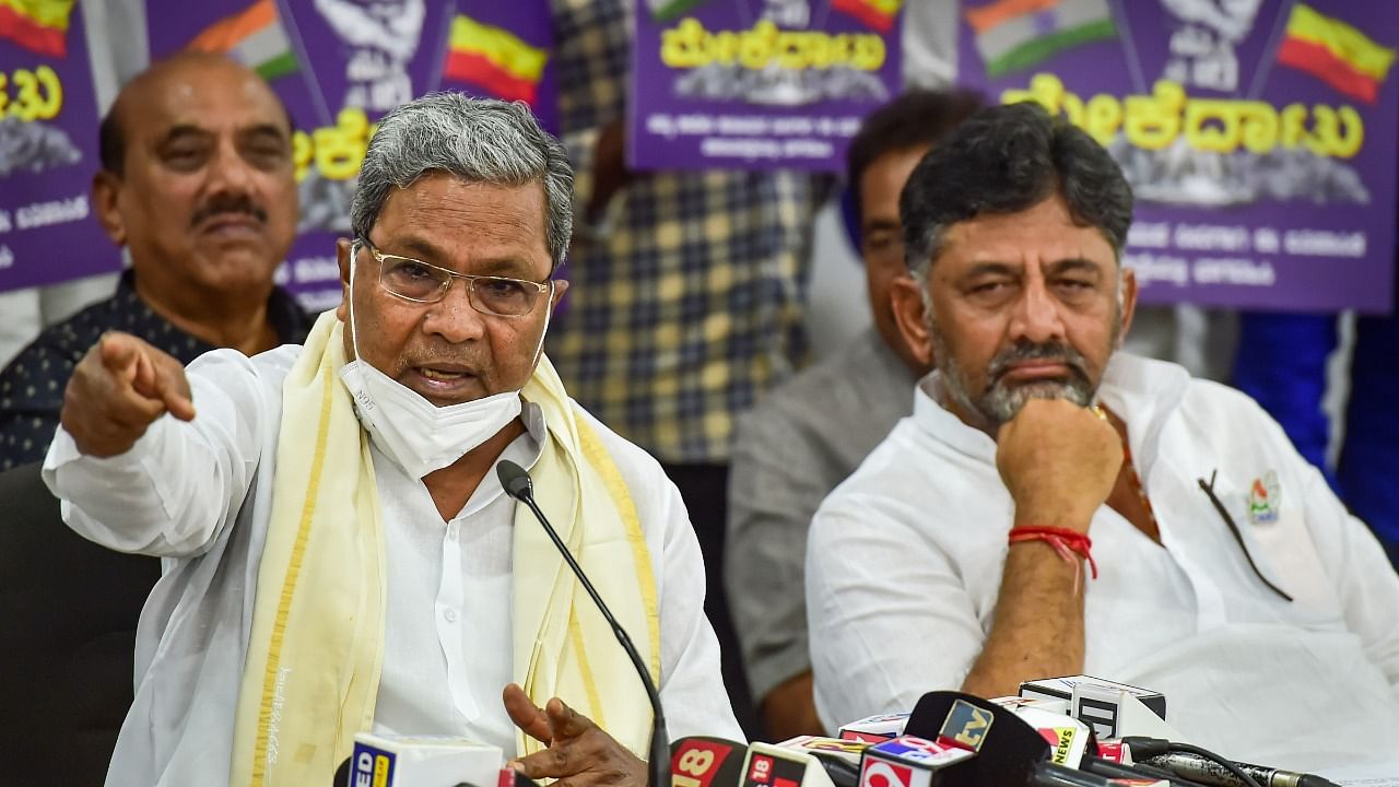 Leader of the Opposition in Karnataka Assembly Siddaramaiah with KPCC President D K Shivakumar (R), addresses a press conference about the party's proposed 'padayatra' from Mekedatu to Bengaluru for the Mekedatu project, at party office in Bengaluru, Wednesday. Credit: PTI Photo