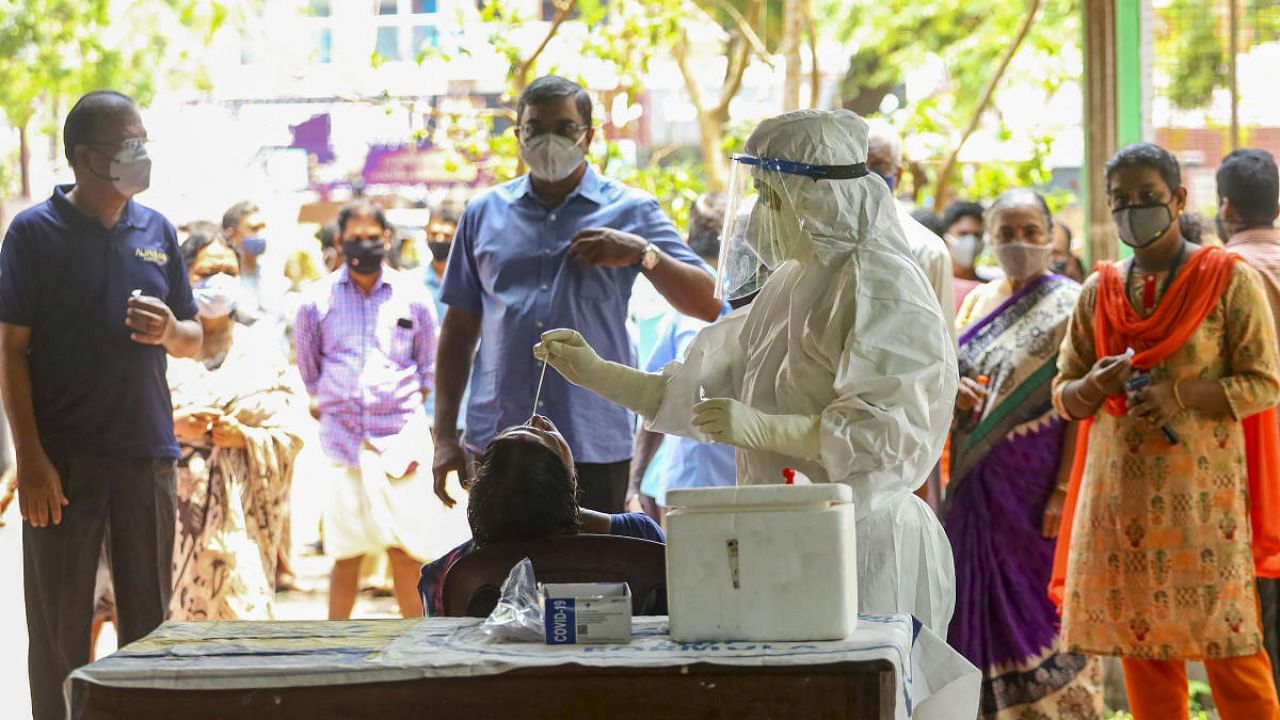 Health workers take swab samples for Covid-19 testing. Credit: PTI Photo