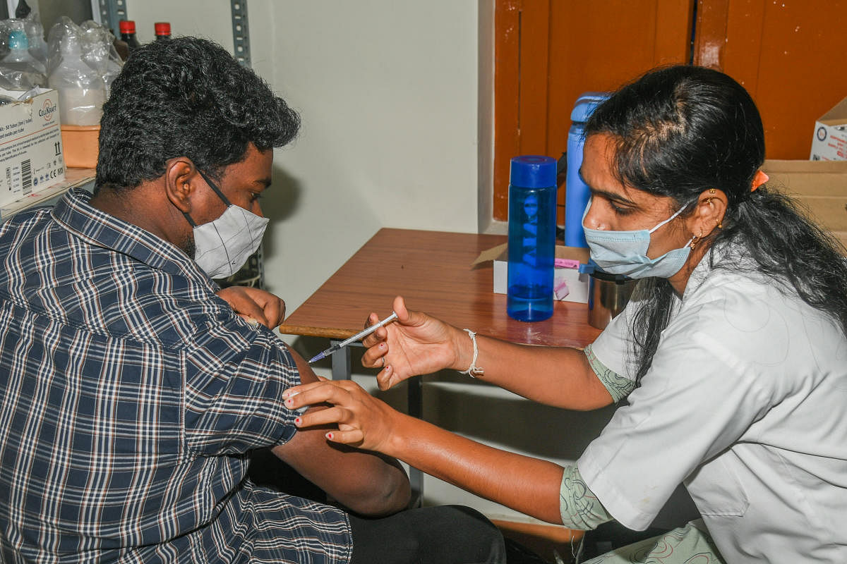 A health worker administers Covid vaccine at a primary health centre in Bengaluru on Wednesday. Credit: DH Photo