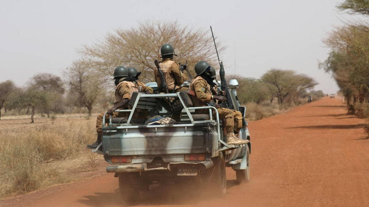 Soldiers from Burkina Faso patrol on the road of Gorgadji in the Sahel area, Burkina Faso. Credit: Reuters Photo
