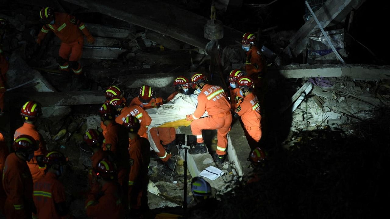 Firefighters carry out rescue operation at the site where a building housing a canteen collapsed following an explosion, in Wulong district of Chongqing, China. Credit: Reuters Photo