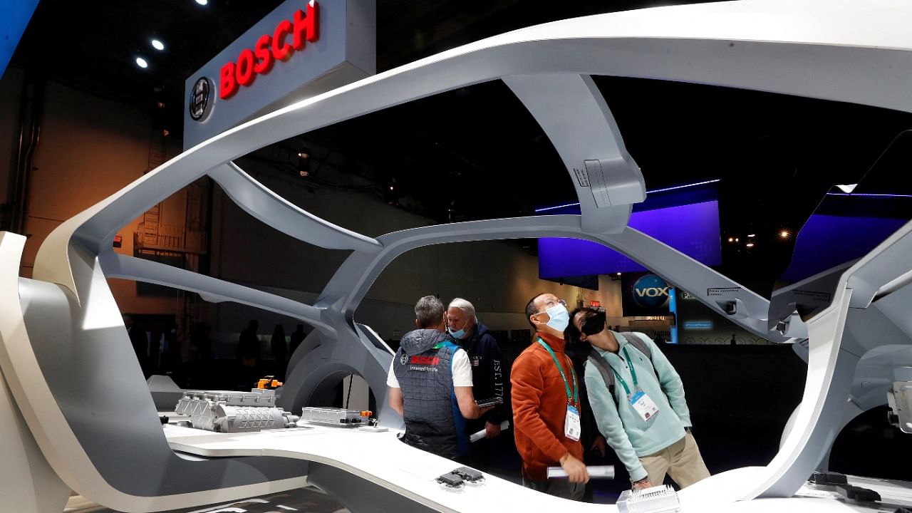 Attendees look over Bosch electronic vehicle hardware in a display during CES 2022. Credit: Reuters Photo