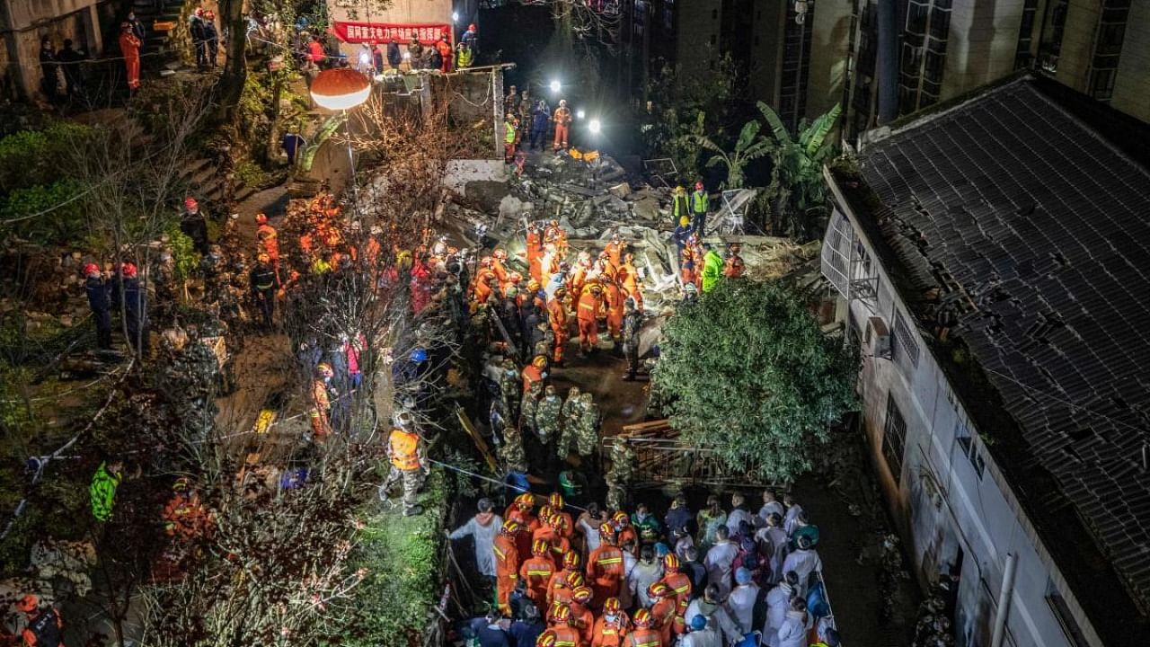 Rescuers search at the scene of an explosion that caused a building to collapse in southwestern China's city of Chongqing. Credit: AFP Photo