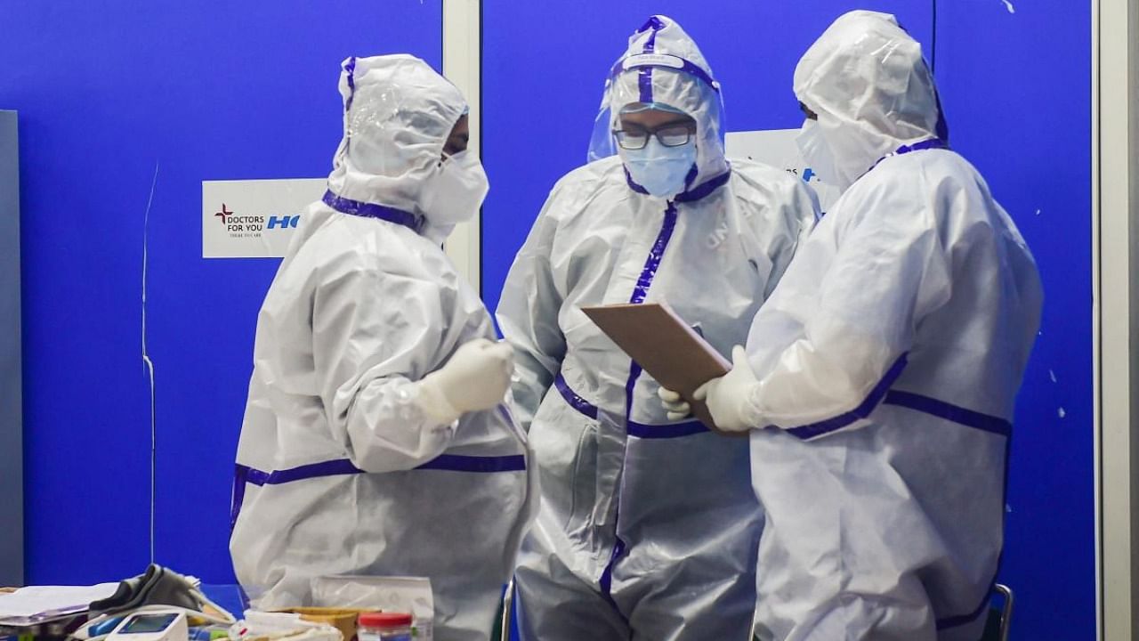 Doctors discus health conditions of Covid-19 infected children inside the Covid Care Centre of the Commonwealth Games (CWG) village, in New Delhi. Credit: PTI Photo